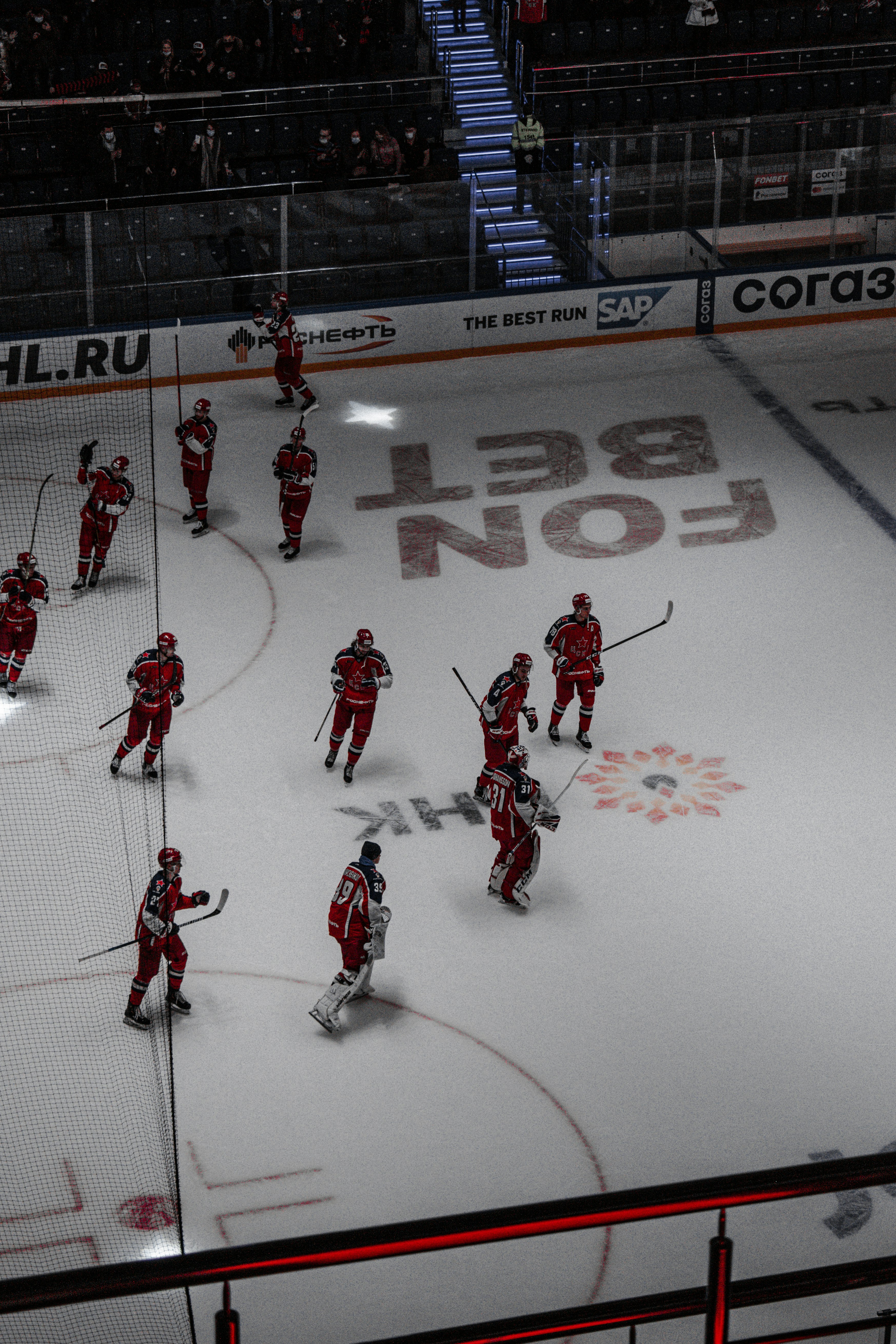 men in red jersey shirt playing ice hockey
